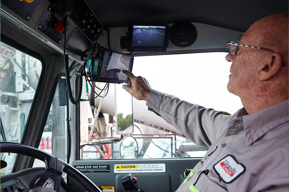trackit2_international man in truck cab touching a touch screen tablet